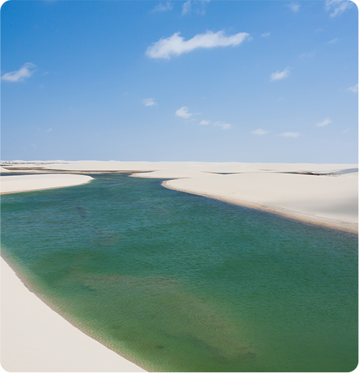 paisagem de uma lagoa azul em meio a dunas de areia branca